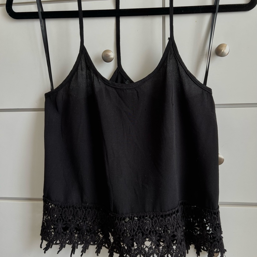 Forever 21 black Racerback tank top with some crochet at the ends in a size XS